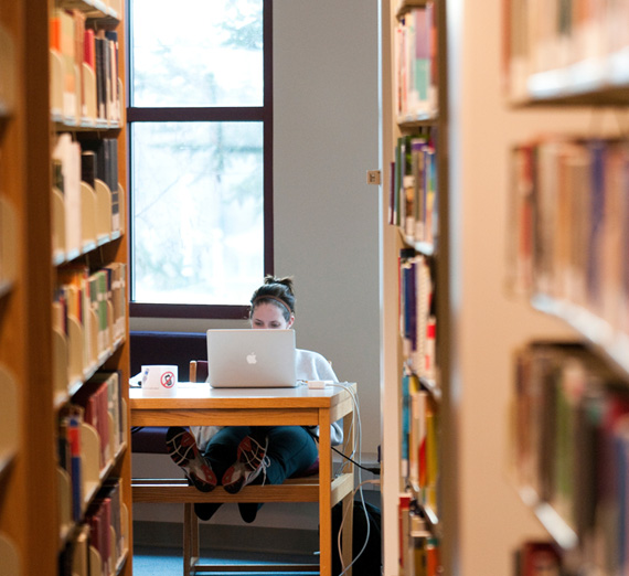 A student works on her computer in Foley Library.