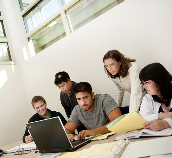 Students and faculty gathered around table.