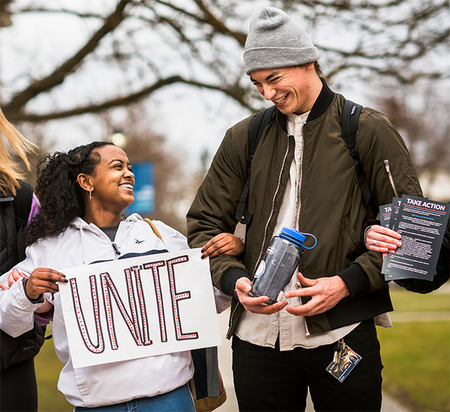 Students linking arms laughing