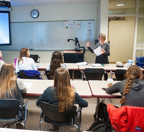 A teacher giving a classroom lecture