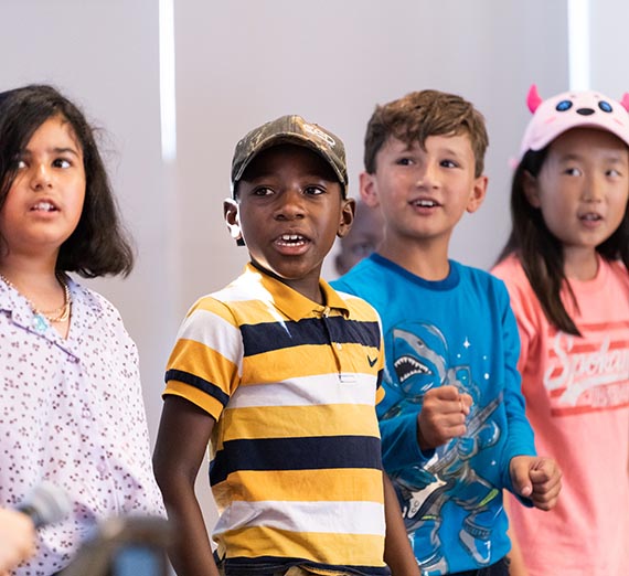 Young children presenting in a classroom
