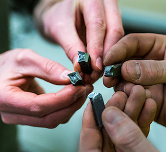 Students hold pieces of a project