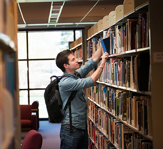 Student doing research in Chastek Library