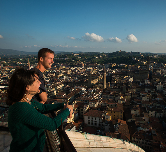 A couple overlooking a city in Italy