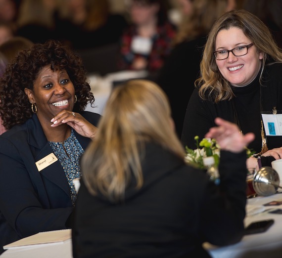 Women shaking hands at the 2018 Women Lead Conference.