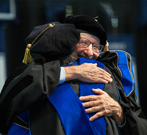 Dr.Chris Francovich hugging 51�Թ� at graduation 