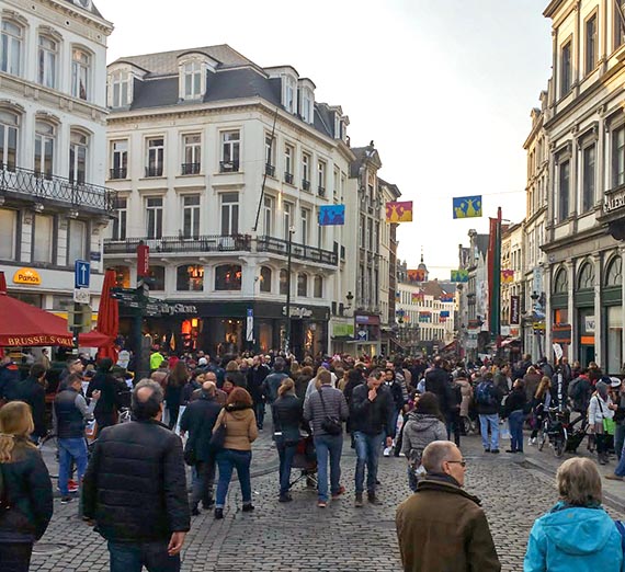 Crowds of people walking on a busy street in Brussels