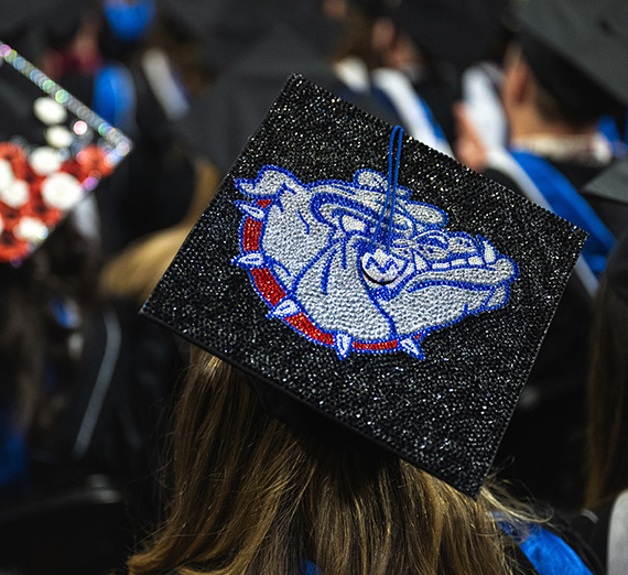 Zags show off their decorated mortar board at commencement