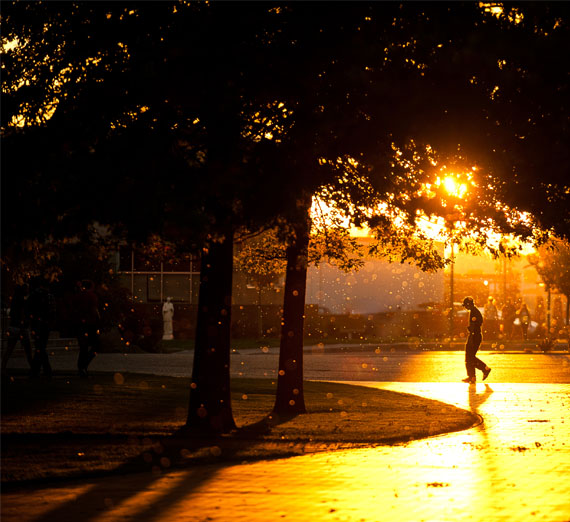 student walking on campus in sunlight 