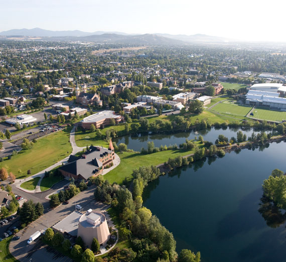 drone view of spokane river and campus 