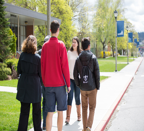 alumni gives a tour to potential students