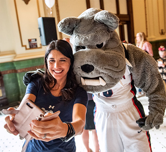 woman taking selfie with mascot