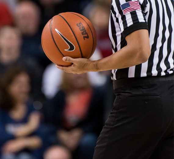 referee holding basketball 