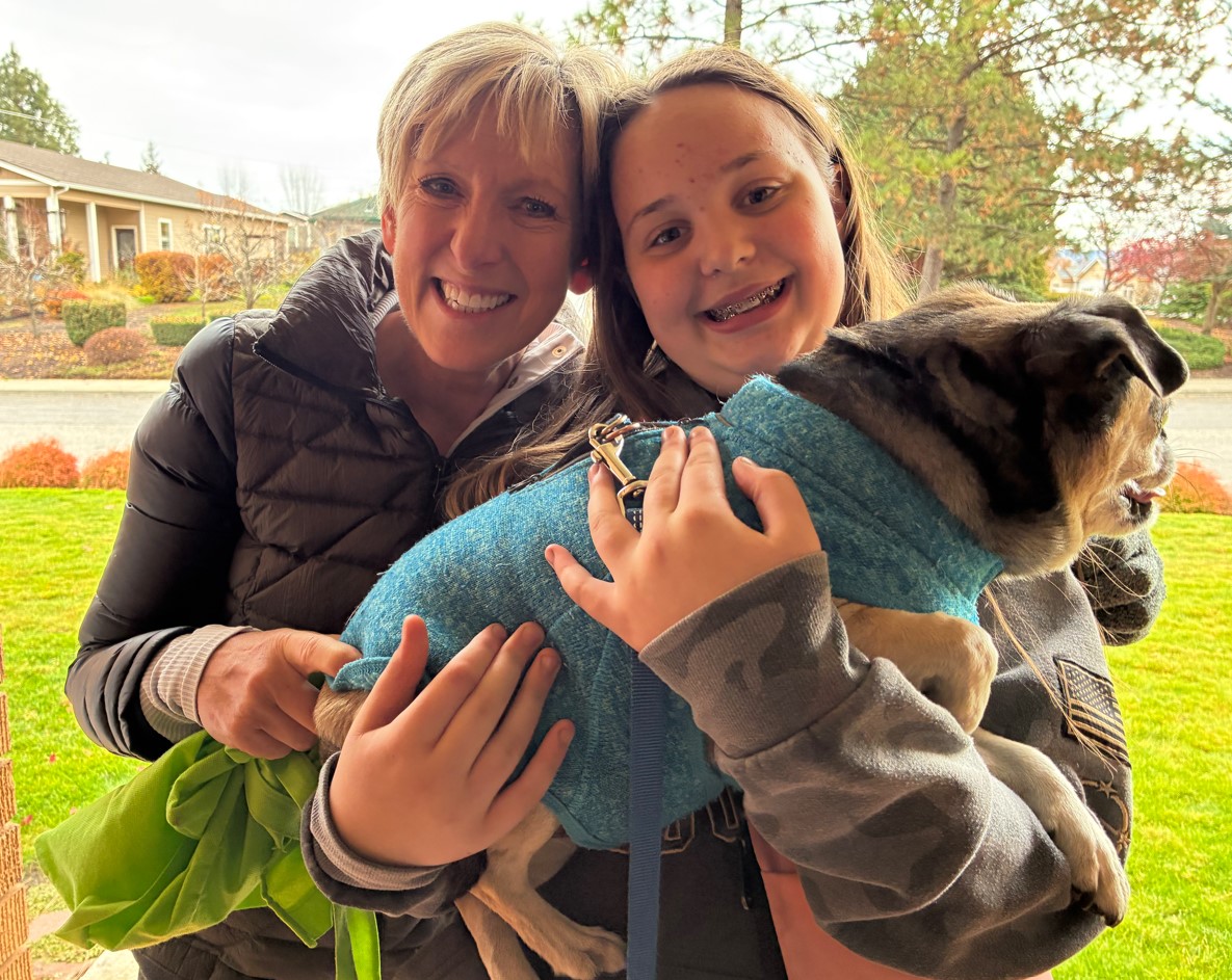 Melissa Taylor and Keylee Frampton holding a dog.