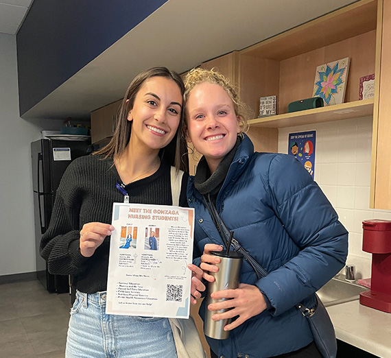 Four people holding trash bags.