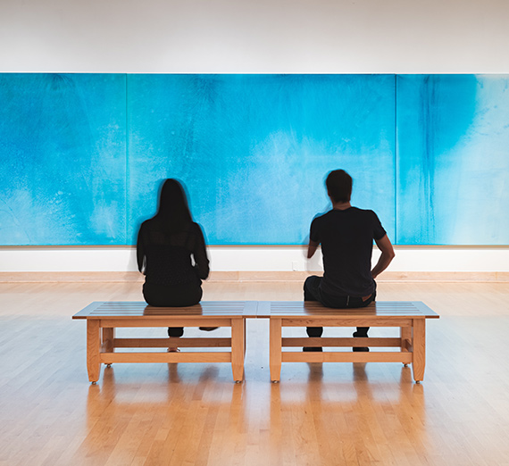 two students looking at art