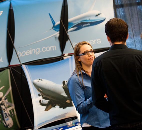 student talking to recruits from Boeing at career fair 