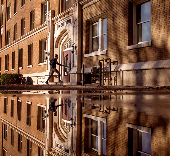 student at entrance of Desmet Hall
