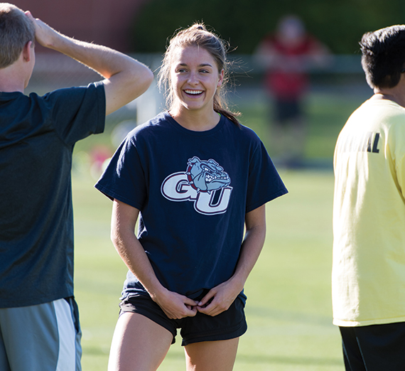 GU student smiles while playing soccer 