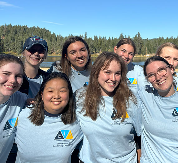 A group of smilng students all wearing ELI t-shirts.