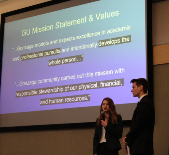 Women's rowing team members packing bags at Second Harvest warehouse