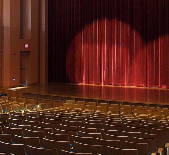 Myrtle Woldson PAC stage with spotlight on curtain