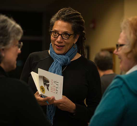 Poet Nikky Finney talks with a group of fans on campus.