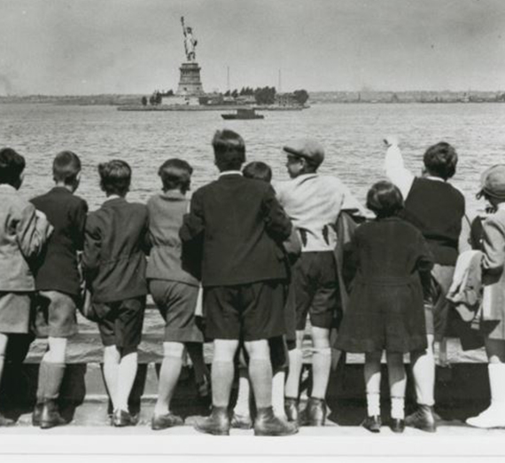 Children aboard the President Harding look at the Statue of Liberty as they pull into New York Harbor. 