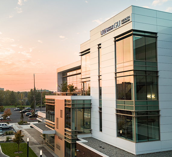 uw-gu health partnership building sunset background