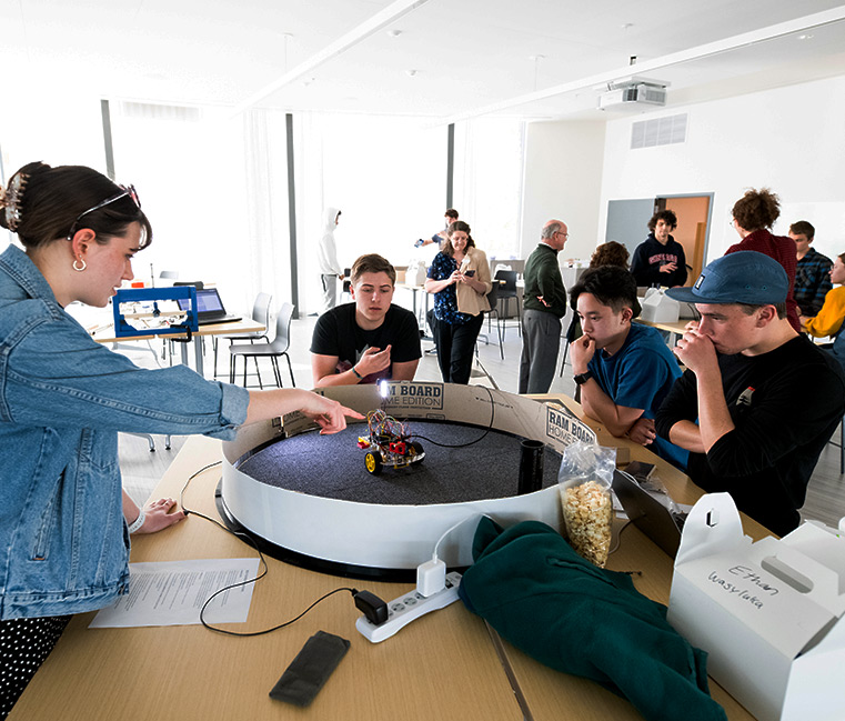 Students discuss robotics in the Integrated Science & Engineering Facility.