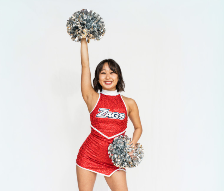 Dancer poses with poms