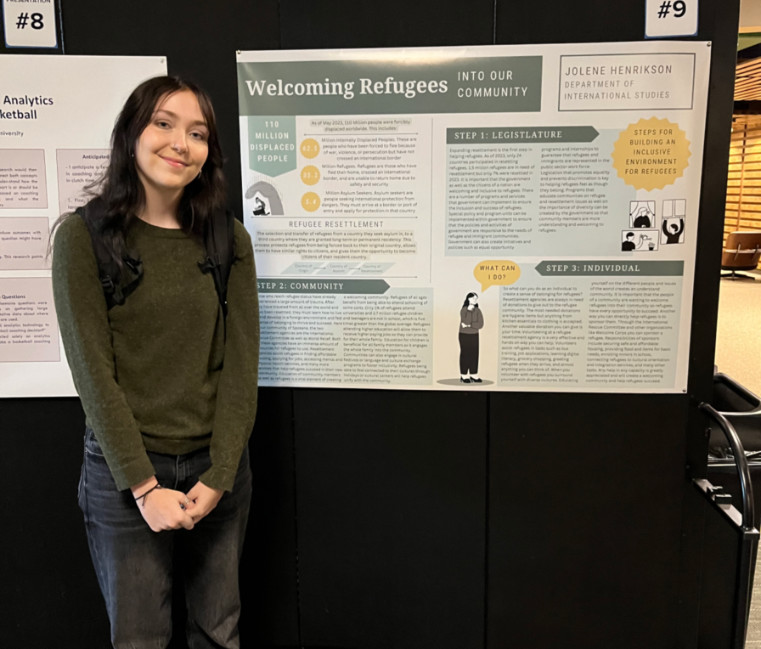 Jolene Henrikson in front of a poster at a conference