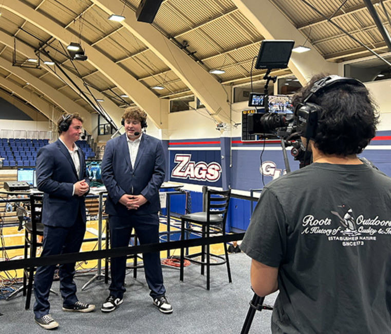 Two Gonzaga University students broadcasting at a sports event in McCarthy Center for the Digital Media Production 482 course. 