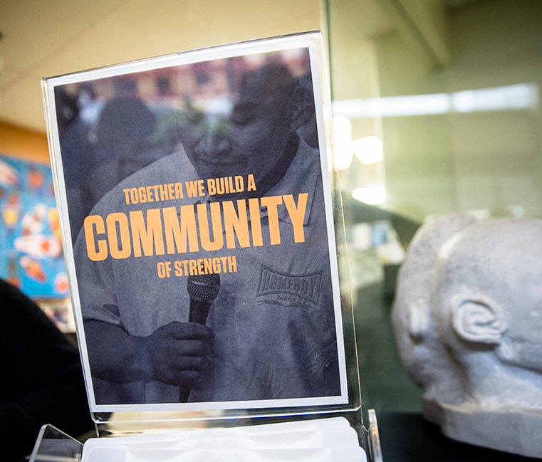 Sign in a window reads Together We Build a Community of Strength