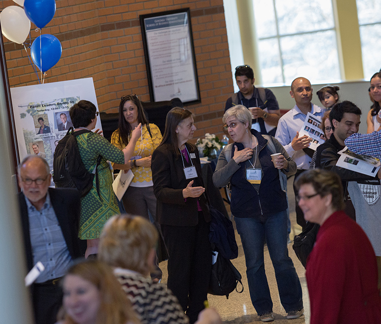 Attendees visiting with each other between sessions at the Student Research Symposium