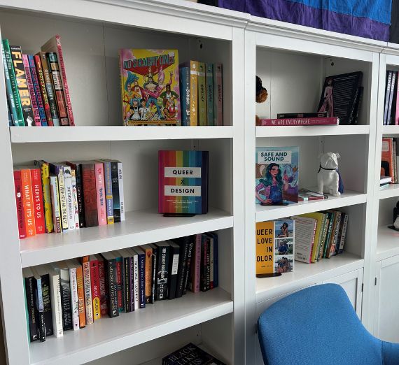 multiple book shelves with queer books