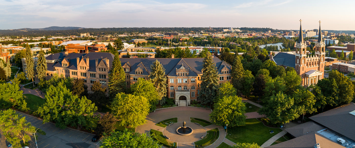 Drone photo showing College Hall building and St. Aloysius chruch at sunset.
