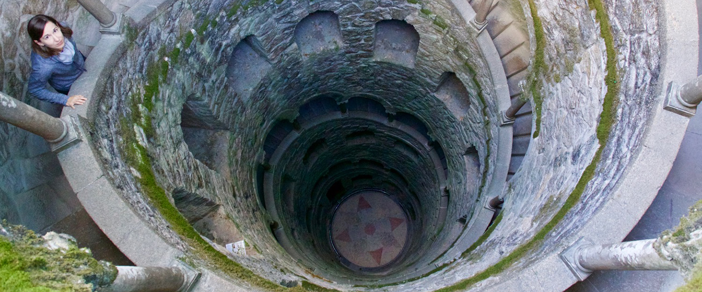 Michelle Chang stands in an ancient spiral stairwell in Portugal