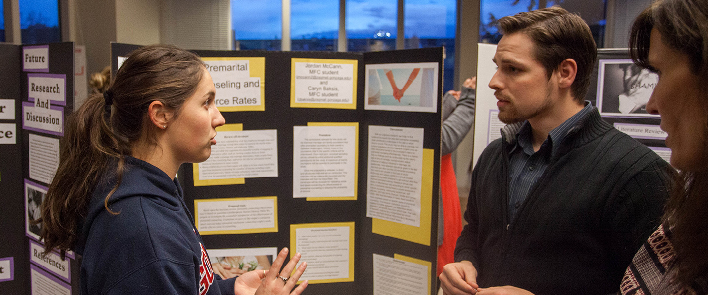 A student presents her research poster