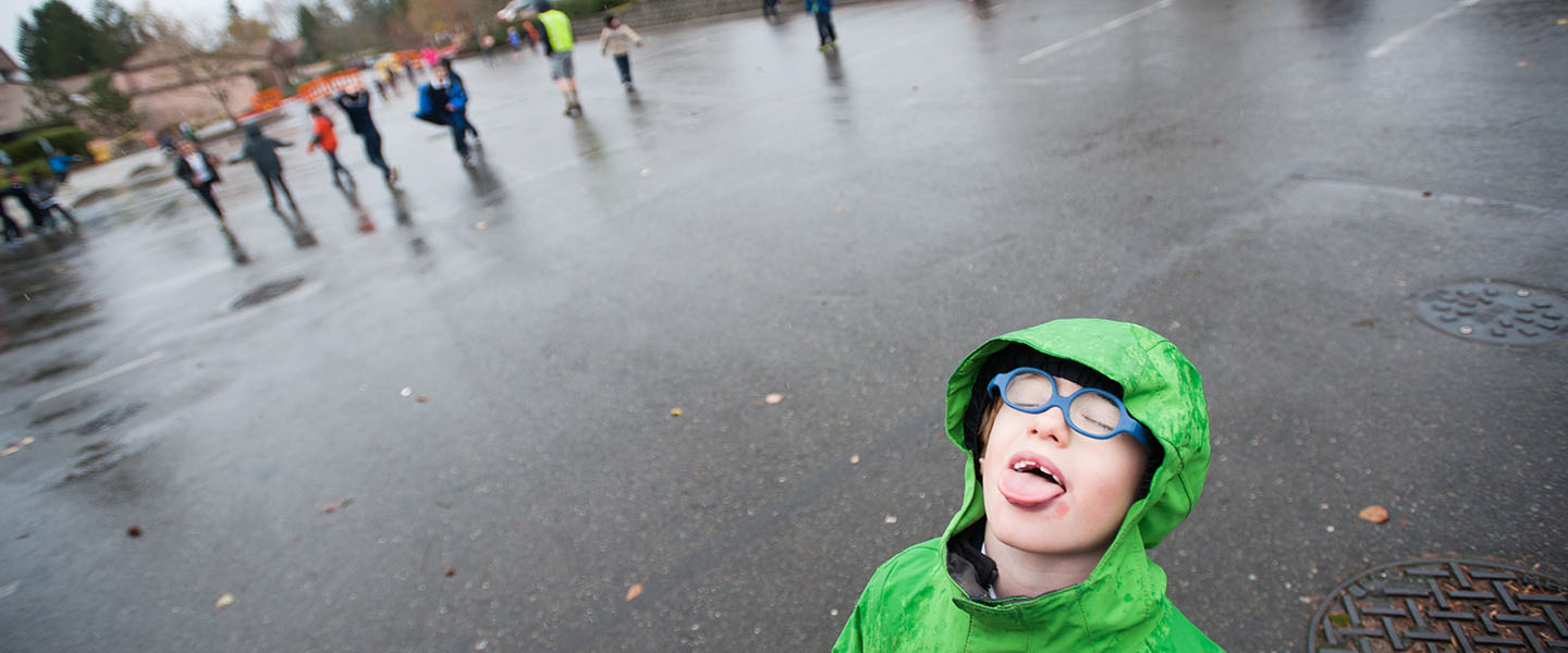 Kids playing in the rain at St. Madeleine's School 