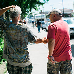 Two people walking shake hands