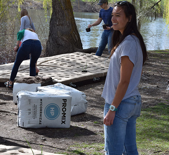 Students setting up a floating wetland in Lake Arthur