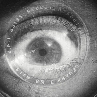 An eye looking a camera lens