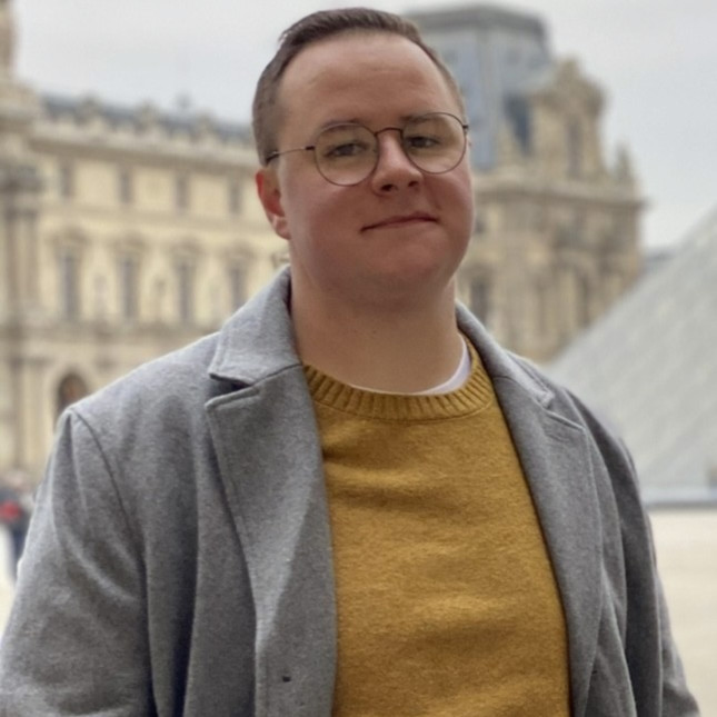 Andrew is facing the camera with a semi-smile