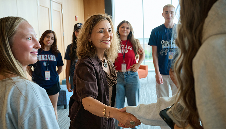 President Katia Passerini and students
