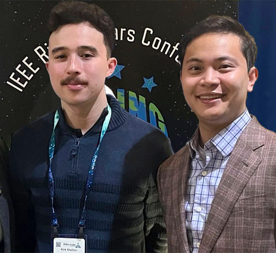 students in front of a conference banner