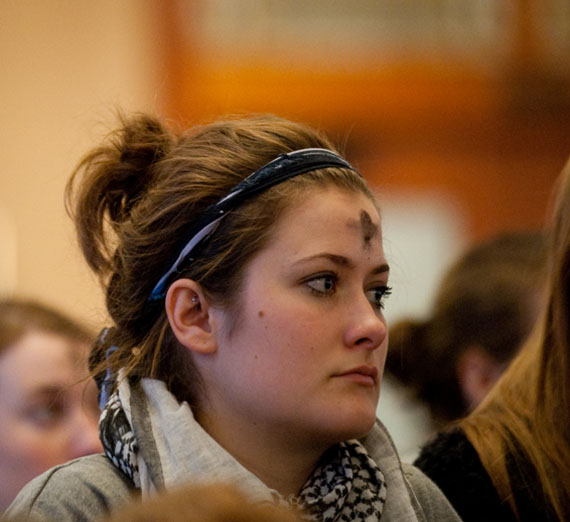 student at ash wednesday mass  