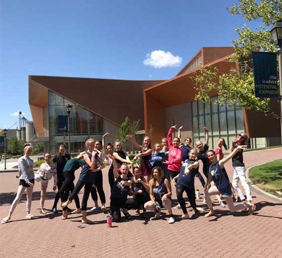 group of dancers pose in front of Woldson