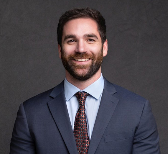 Michael poses in a blue suit