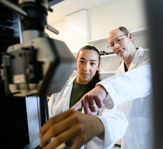 Gary Weber and Raven Haines work in the Materials Lab inside the Bollier Center.